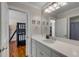 Bathroom with a bright vanity, large mirror, and doorway leading to the bunkroom at 4006 Hartnett Blvd, Isle of Palms, SC 29451