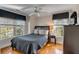 Comfortable bedroom features natural light from multiple windows and a ceiling fan at 4006 Hartnett Blvd, Isle of Palms, SC 29451