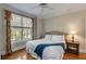 Comfortable bedroom featuring a ceiling fan, large windows, and hardwood floors at 4006 Hartnett Blvd, Isle of Palms, SC 29451