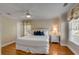 Bedroom features hardwood floors, large bed, ceiling fan, and large windows with custom valances at 4006 Hartnett Blvd, Isle of Palms, SC 29451