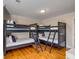 Spacious bunkroom with dark triple bunkbeds and wood floors at 4006 Hartnett Blvd, Isle of Palms, SC 29451