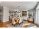 Bright dining room featuring hardwood floors, stylish furnishings, and built-in shelving for elegant dining at 4006 Hartnett Blvd, Isle of Palms, SC 29451
