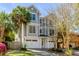 Charming two-story home with a well-manicured lawn, a paved driveway, and a two car garage at 4006 Hartnett Blvd, Isle of Palms, SC 29451