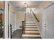 The bright, neutral foyer features tile flooring and a staircase with wood and white accents at 4006 Hartnett Blvd, Isle of Palms, SC 29451