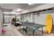 Spacious garage with ping pong table, golf cart, and surfboard at 4006 Hartnett Blvd, Isle of Palms, SC 29451