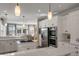 Bright kitchen featuring white cabinets, stone countertops, stainless appliances, an island cooktop, open to the dining area at 4006 Hartnett Blvd, Isle of Palms, SC 29451