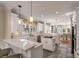 Bright open kitchen features white cabinets, stone countertops, breakfast bar, open to the dining area at 4006 Hartnett Blvd, Isle of Palms, SC 29451