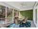 Outdoor screened porch featuring a dining table and comfortable seating at 4006 Hartnett Blvd, Isle of Palms, SC 29451