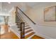 Beautiful staircase featuring hardwood steps, white risers, and a dark decorative metal banister at 4006 Hartnett Blvd, Isle of Palms, SC 29451
