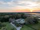 Sunset aerial of the waterfront estate with pool, guest house, and acreage at 4020 Betsy Kerrison Pkwy, Johns Island, SC 29455
