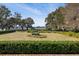 Well-manicured backyard with manicured hedges, a statue, and picturesque views of the water at 4020 Betsy Kerrison Pkwy, Johns Island, SC 29455