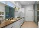 A modern bathroom showcases double sinks, expansive mirror, and ample storage, next to a glass enclosed shower at 4020 Betsy Kerrison Pkwy, Johns Island, SC 29455