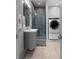 Modern bathroom with sleek fixtures, stand-up shower and conveniently located washer and dryer at 4020 Betsy Kerrison Pkwy, Johns Island, SC 29455