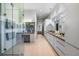 A modern bathroom showcases double sinks, expansive mirror, and ample storage, next to a glass enclosed shower at 4020 Betsy Kerrison Pkwy, Johns Island, SC 29455
