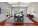 Bright dining room with large windows, modern table and seating for ten at 4020 Betsy Kerrison Pkwy, Johns Island, SC 29455