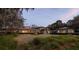 Wide, grassy yard with a modern-style home at dusk surrounded by trees at 4020 Betsy Kerrison Pkwy, Johns Island, SC 29455