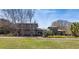 A modern home with unique architectural details, large windows and mature trees in front at 4020 Betsy Kerrison Pkwy, Johns Island, SC 29455