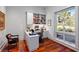 Cozy home office featuring custom built-ins, a large window, hardwood floors, and a comfortable workspace at 4020 Betsy Kerrison Pkwy, Johns Island, SC 29455