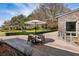 Outdoor patio featuring a dining table with umbrella and stone accents, offering scenic backyard views at 4020 Betsy Kerrison Pkwy, Johns Island, SC 29455