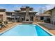 Backyard pool with modern design, surrounded by a stone patio and lush landscape for relaxation and recreation at 4020 Betsy Kerrison Pkwy, Johns Island, SC 29455