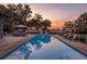 Sparkling pool surrounded by a wooden deck and serene nature, perfect for relaxation at sunset at 4020 Betsy Kerrison Pkwy, Johns Island, SC 29455