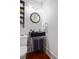Compact powder room with unique sink, mirror and dark fixtures at 4020 Betsy Kerrison Pkwy, Johns Island, SC 29455