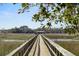 Picturesque walkway leading to a private dock and boat lift, surrounded by beautiful marshland at 4020 Betsy Kerrison Pkwy, Johns Island, SC 29455