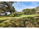 Expansive grassy yard with mature trees and partial water view, evoking a serene atmosphere at 4020 Betsy Kerrison Pkwy, Johns Island, SC 29455