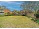 Large backyard with lush green grass, perimeter fence, and garden area at 406 Mendenhall St, Summerville, SC 29483