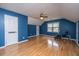 Bright blue bedroom featuring wood floors, a ceiling fan, and a window with natural light at 406 Mendenhall St, Summerville, SC 29483