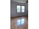 Bright bedroom features gleaming hardwood floors, a ceiling fan, and a large window with views of the outdoors at 406 Mendenhall St, Summerville, SC 29483