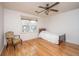Bright bedroom featuring wood floors, a ceiling fan, and a window with natural light at 406 Mendenhall St, Summerville, SC 29483