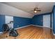 Bright blue bedroom featuring wood floors, a ceiling fan, and a window with natural light at 406 Mendenhall St, Summerville, SC 29483