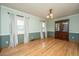 Bright dining room with hardwood floors, large windows, and classic chandelier at 406 Mendenhall St, Summerville, SC 29483