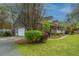 Charming brick home with a welcoming front porch, garage, and well-manicured lawn at 406 Mendenhall St, Summerville, SC 29483