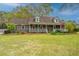 Charming brick home with a welcoming front porch and well-manicured lawn at 406 Mendenhall St, Summerville, SC 29483