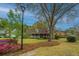 Quaint home with beautiful landscaping and a large tree in the front yard at 406 Mendenhall St, Summerville, SC 29483