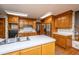 Spacious kitchen with lots of wooden cabinets, stainless appliances, and an adjacent doorway with stairs at 406 Mendenhall St, Summerville, SC 29483