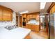 Kitchen featuring wood cabinetry, white countertops, and stainless steel appliances with adjacent door at 406 Mendenhall St, Summerville, SC 29483