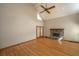 Spacious living room with hardwood floors, brick fireplace, and access to the patio at 406 Mendenhall St, Summerville, SC 29483