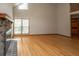 Open living room with hardwood floors, brick fireplace, and large windows providing ample natural light at 406 Mendenhall St, Summerville, SC 29483