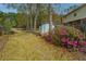 Backyard view featuring a shed with flower bushes next to a wood fence and grassy area at 406 Mendenhall St, Summerville, SC 29483