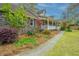 Lovely home featuring a side view, showing its brick facade and lush landscaping at 406 Mendenhall St, Summerville, SC 29483