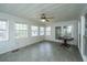 Bright sunroom with multiple windows, tile flooring, and a ceiling fan, perfect for relaxation at 406 Mendenhall St, Summerville, SC 29483