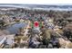 Aerial view shows neighborhood street lined with houses and a small lake in the background at 4108 Whiting St, Mount Pleasant, SC 29466