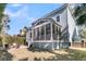 Expansive backyard with a screened porch, a patio seating area, and a well-maintained lawn at 4108 Whiting St, Mount Pleasant, SC 29466