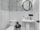 Stylish powder room with patterned wallpaper, modern fixtures, pedestal sink and neutral decor at 4108 Whiting St, Mount Pleasant, SC 29466
