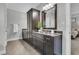 Bathroom vanity with dark wood cabinets, granite countertops, and decorative mirror at 4108 Whiting St, Mount Pleasant, SC 29466