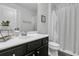 Modern bathroom with dark vanity, striped shower curtain, and sleek fixtures at 4108 Whiting St, Mount Pleasant, SC 29466