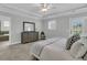 Spacious bedroom featuring tray ceiling, large dresser and attached bathroom at 4108 Whiting St, Mount Pleasant, SC 29466